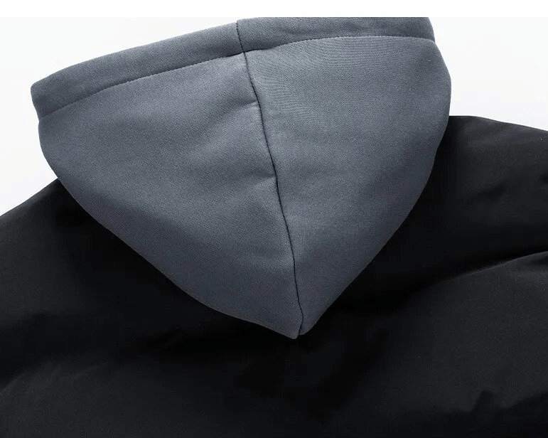 Close-up of a fashionable unisex hooded down jacket with detachable hood, featuring a sleek black and gray design for winter style.